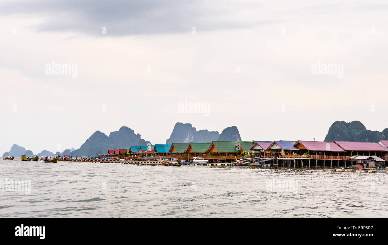 Pier and restaurants floating over the sea at Punyi Island or Koh Panyee during a boat tour in the Ao Phang Nga Bay, Thailand Stock Photo