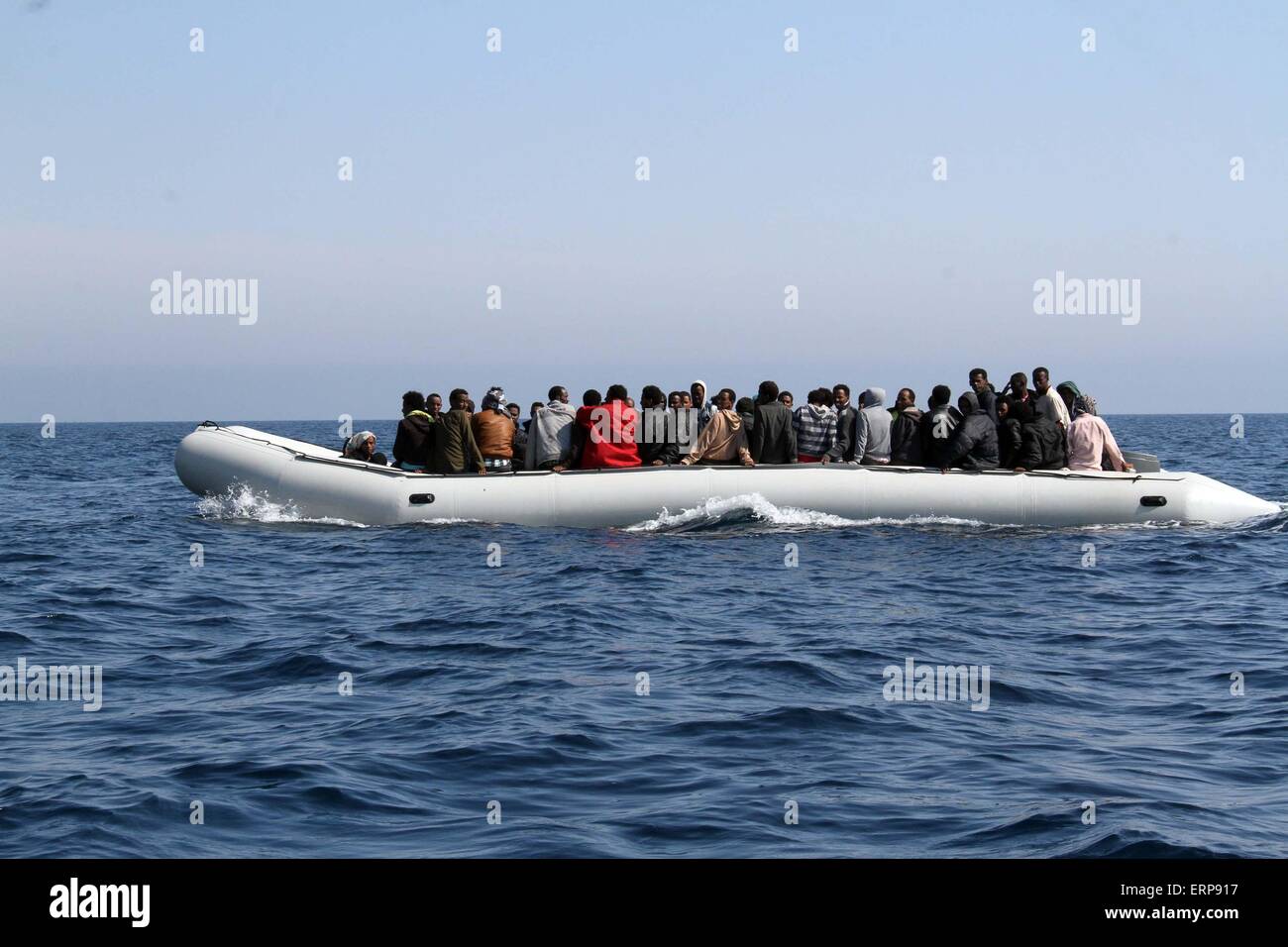 Tripoli, Libya. 06th June, 2015. A batch of illegal immigrants sit on a boat of the Libyan coast guard near Garabulli, Libya on June 6, 2015. The Libyan coast guard intercepted dozens of sub-Saharan nationals trying to stow away to Europe from Libyan coast. Credit:  Xinhua/Alamy Live News Stock Photo