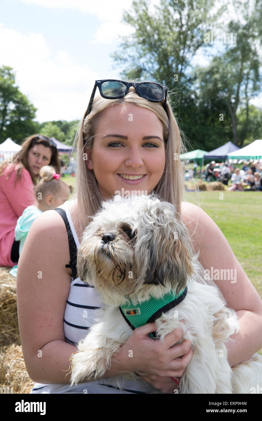 Green St Green, UK. 6th June 2015. A young lady with her dog enjoy the St Christopher's Wild West Fair and food festival. Credit:  Keith Larby/Alamy Live News Stock Photo