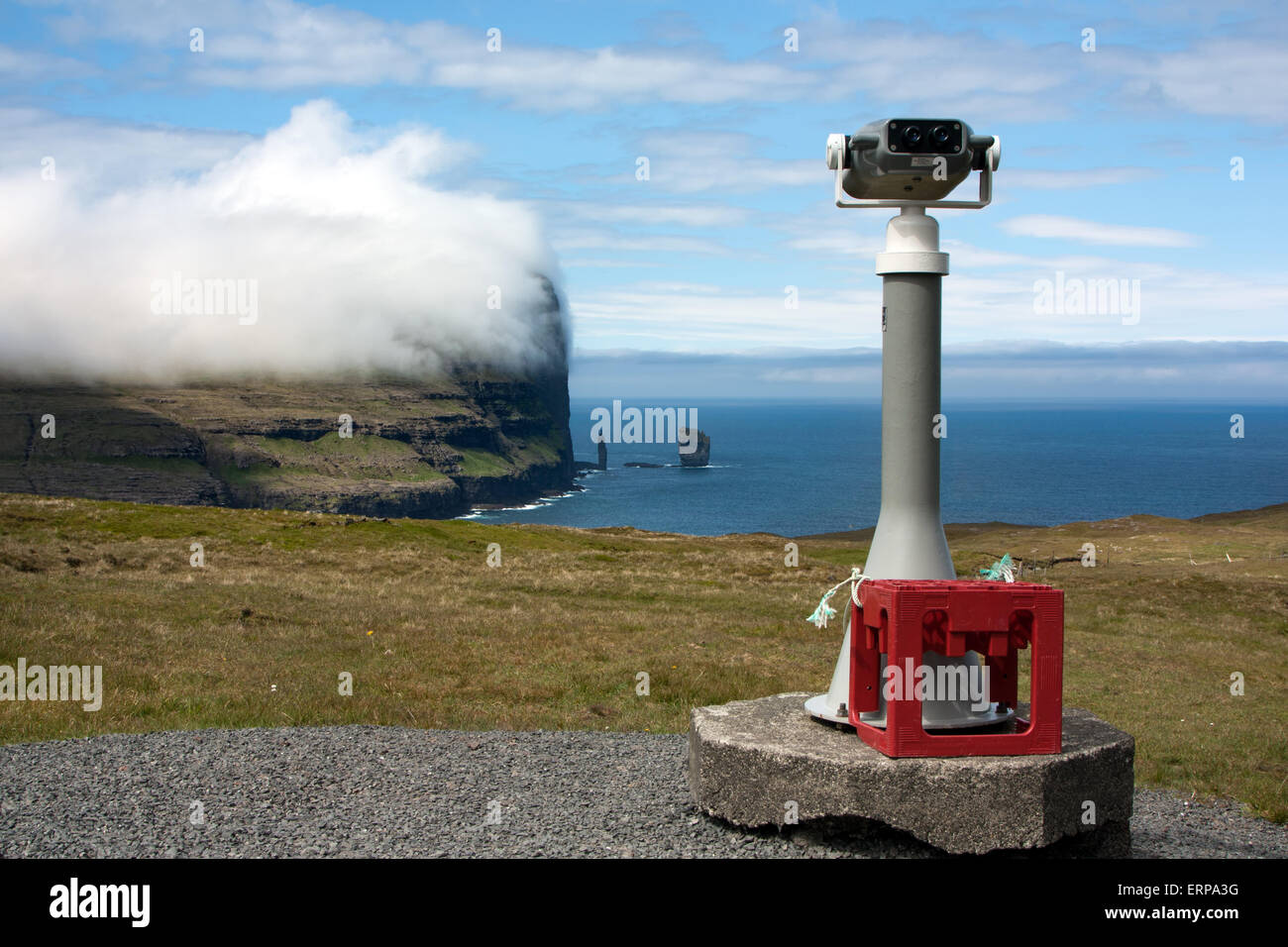Faroe Islands, panoramic binocular telescope pointing giant sea cliffs Stock Photo