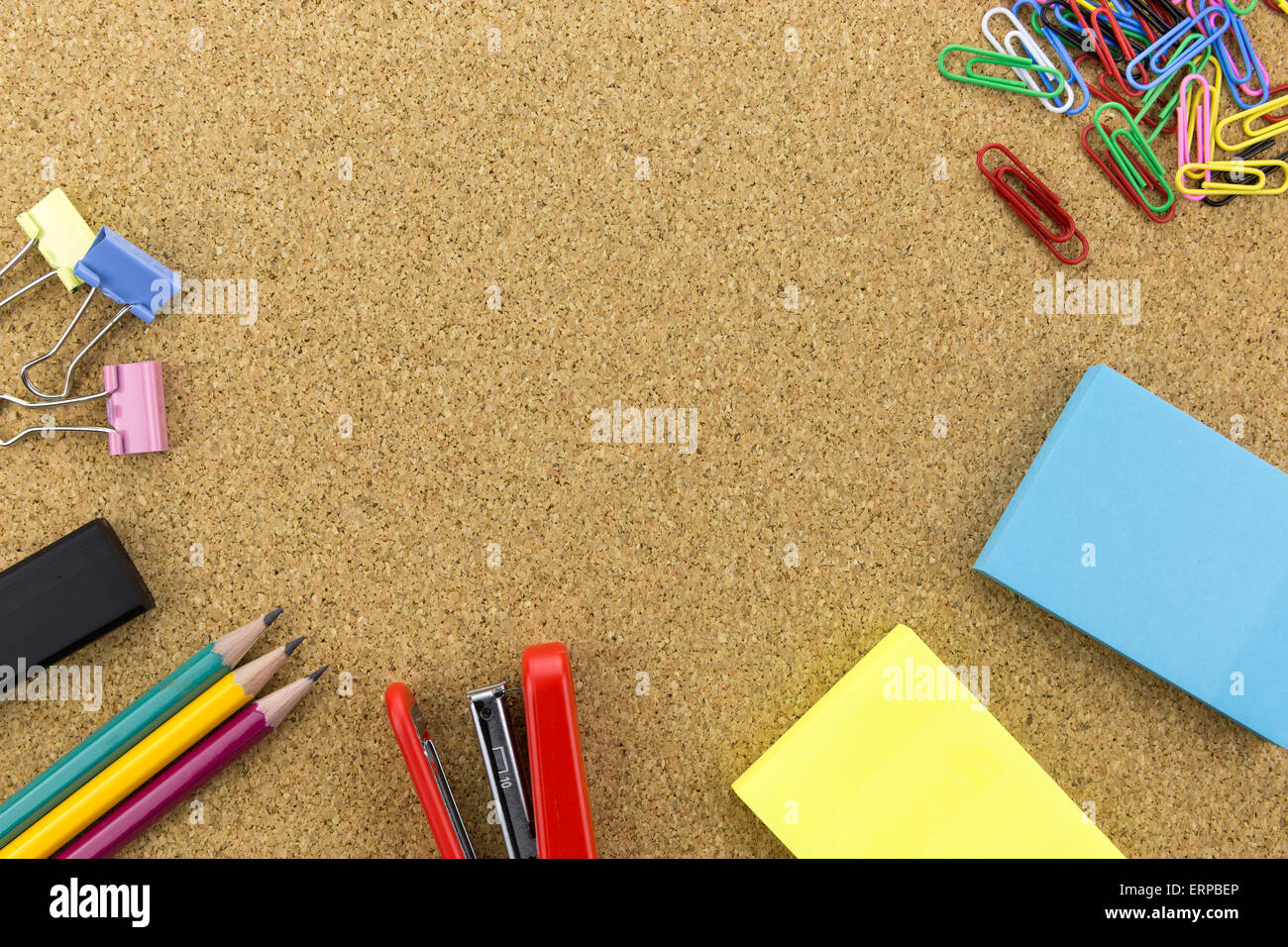 wallpaper stationary on cork board with many office supplies tools Stock Photo