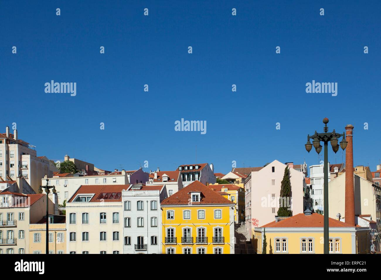 Colourful pombaline style buildings in Lisbon against a bright blue sky in summer Stock Photo