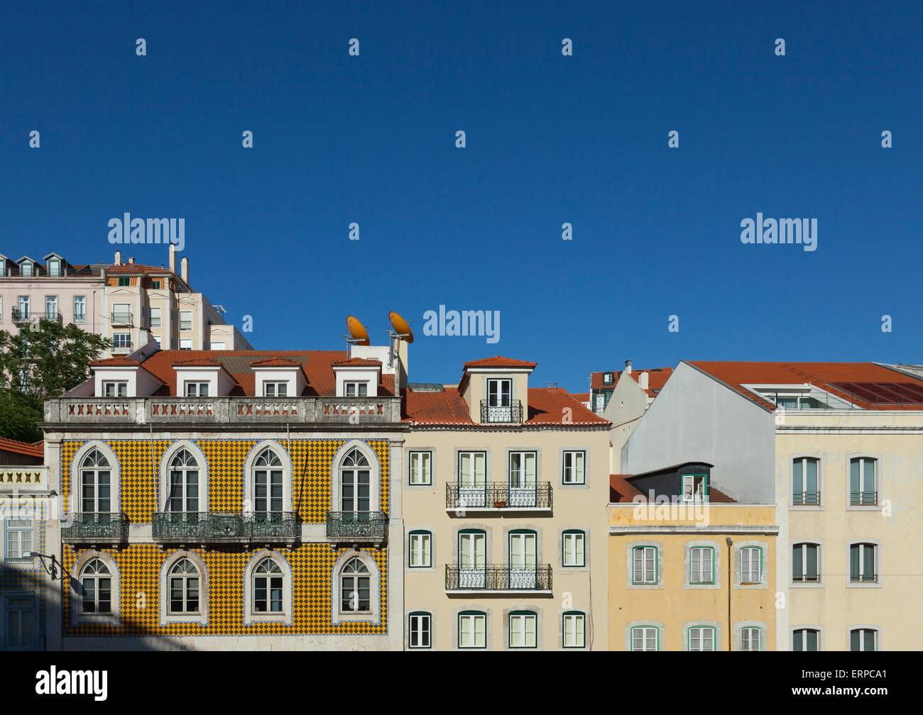 Colourful pombaline style buildings in Lisbon against a bright blue sky in summer Stock Photo