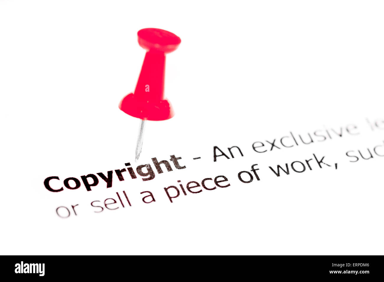 Word COPYRIGHT pinned on white paper with red pushpin, available copy ...