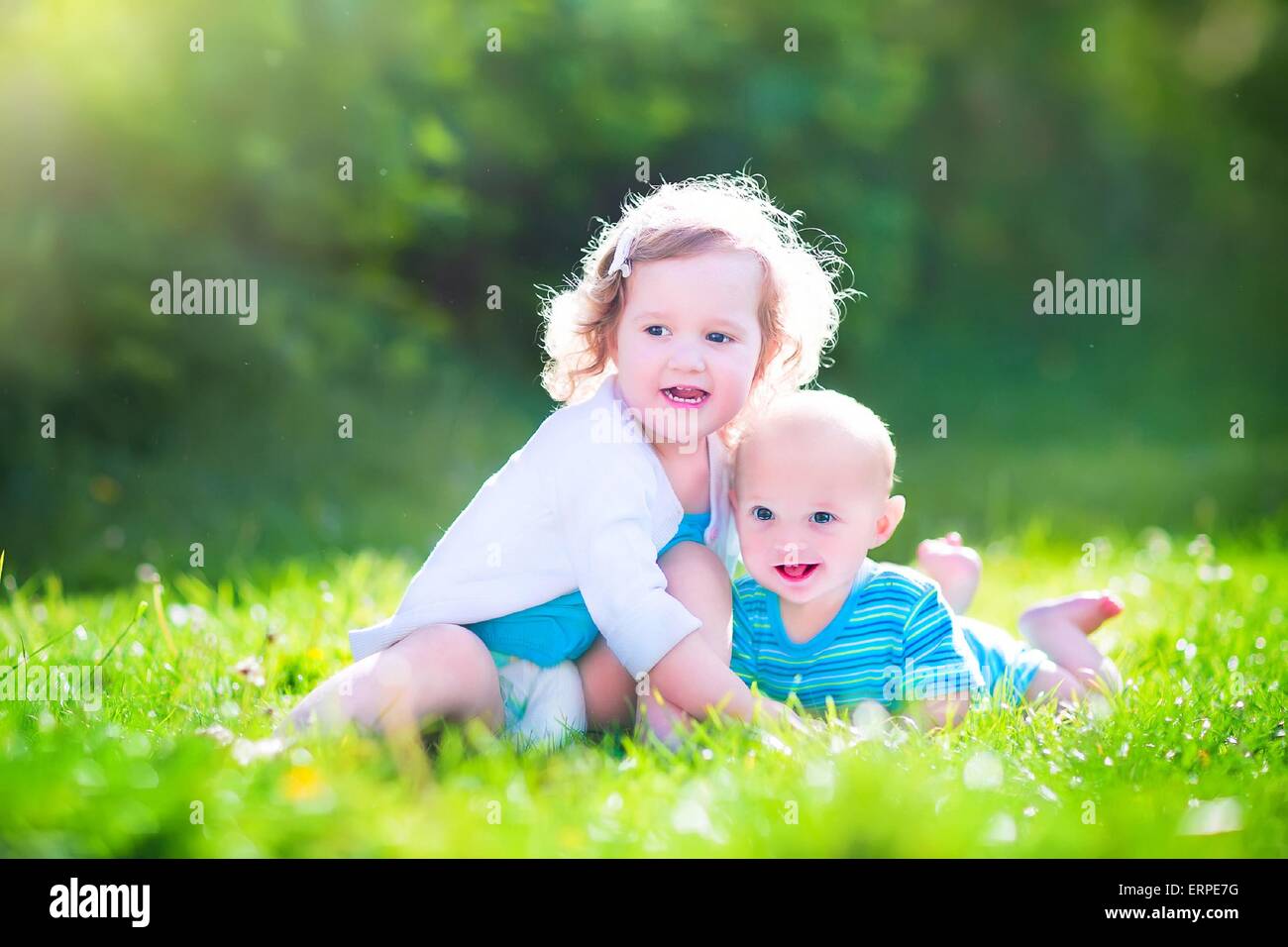 cute little baby boy and a happy laughing toddler girl brother and baby cute image