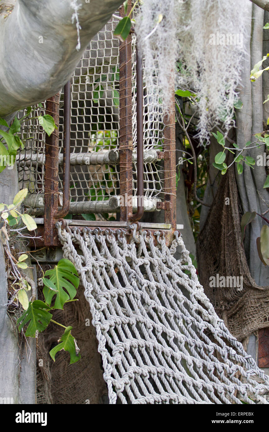 Tree house with a netted stair for kids who want to play pretend games Stock Photo