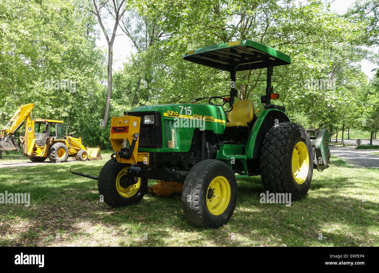 John deere tractor with cab and mower in park, USA. Stock Photo