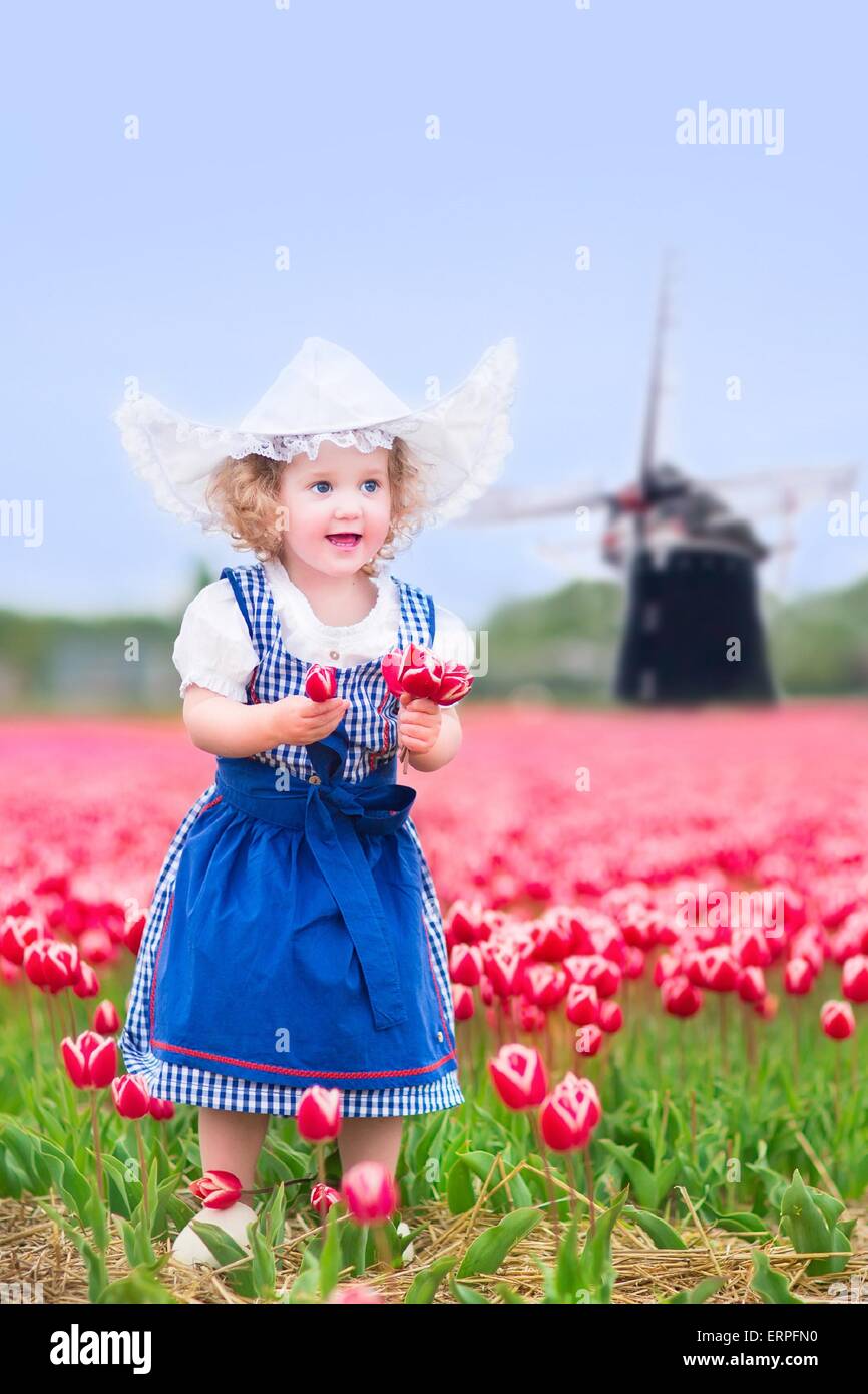 Toddler girl wearing Dutch traditional national costume dress and hat