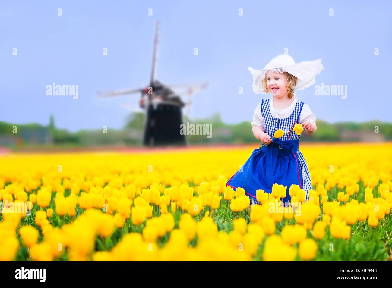 Toddler girl wearing Dutch traditional national costume dress and hat