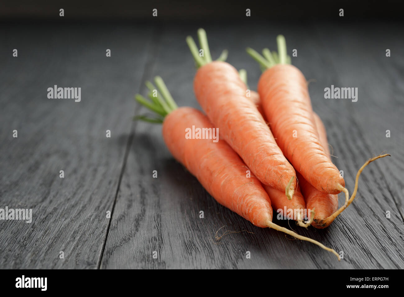 fresh carrots on old oak table with copy space Stock Photo