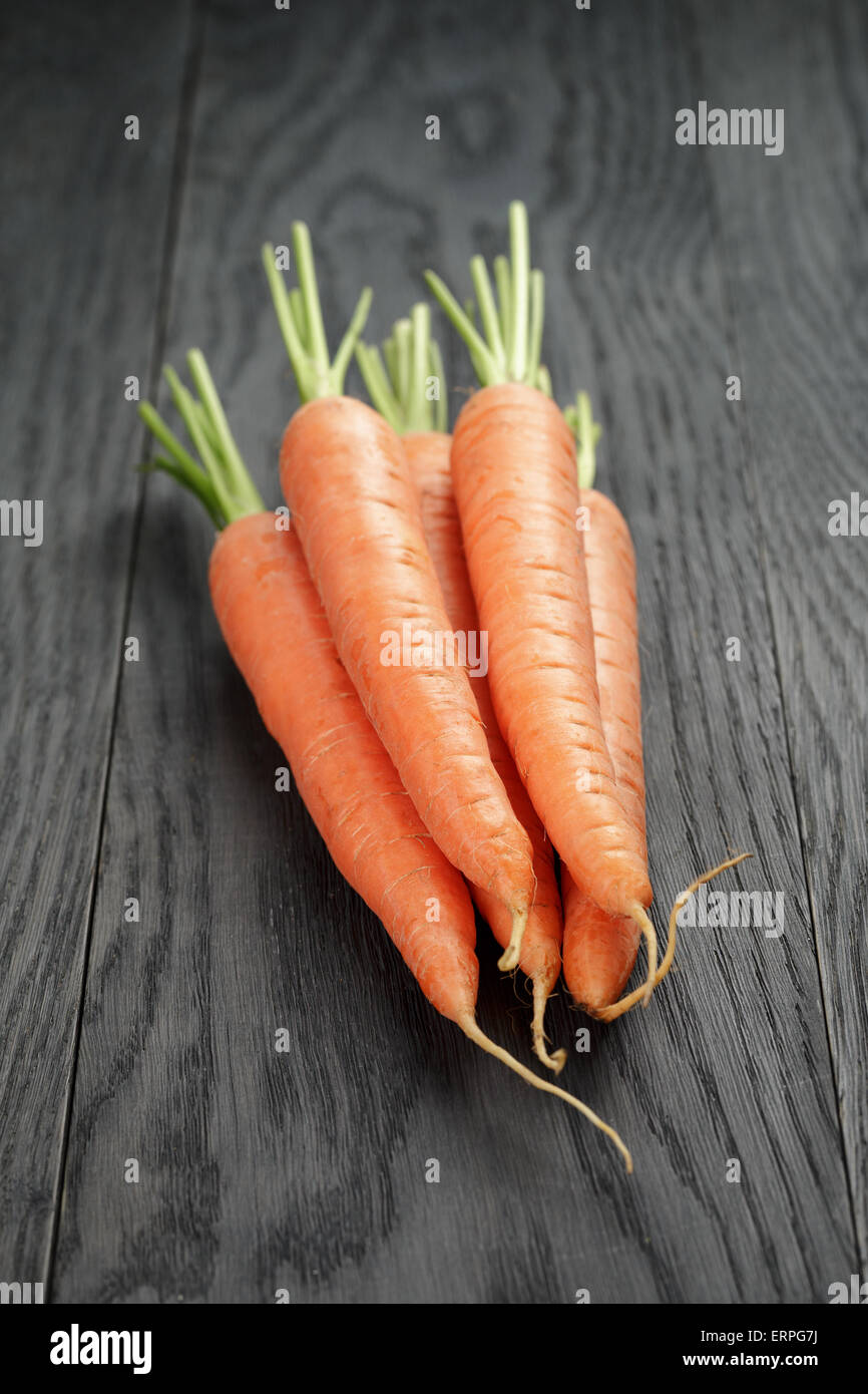 fresh carrots on old oak table Stock Photo