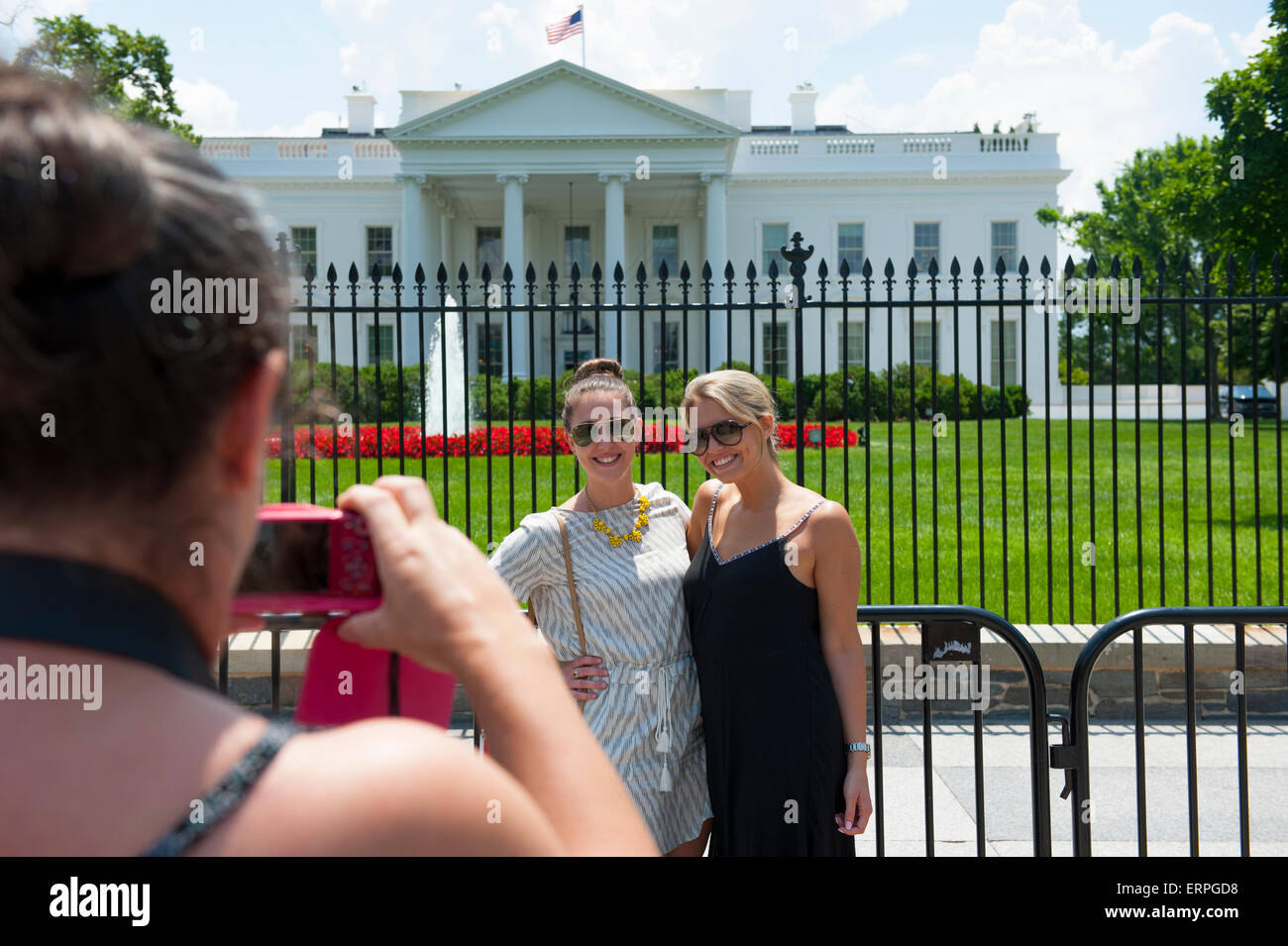 USA Washington DC White House women get a photo taken of themselves in front the presidents home Stock Photo