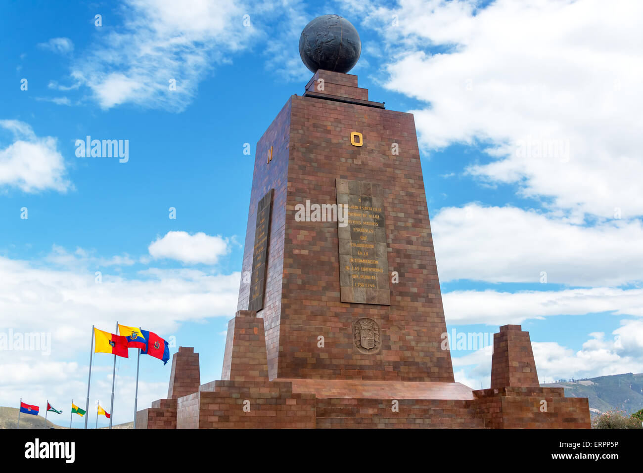 Monument to the Equator in Quito, Ecuador with the Ecuadorian flag in the bottom left Stock