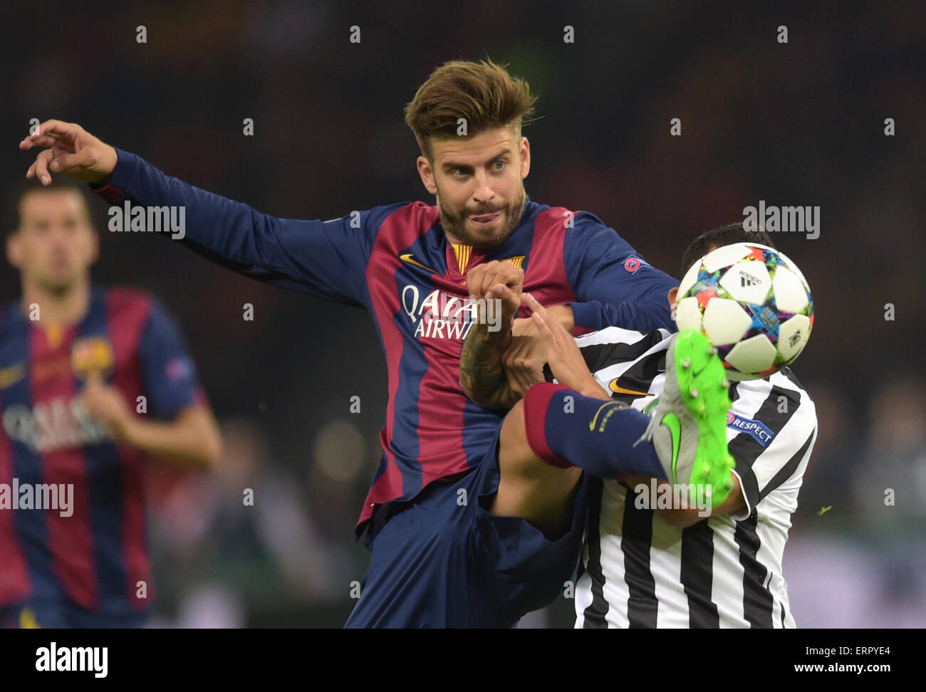 Berlin, Germany. 06th June, 2015. dpatopbilder Barcelona's Gerard Pique (L)  and Carlos Tevez of Juventus vie for the ball during the UEFA Champions  League final soccer match between Juventus FC and FC