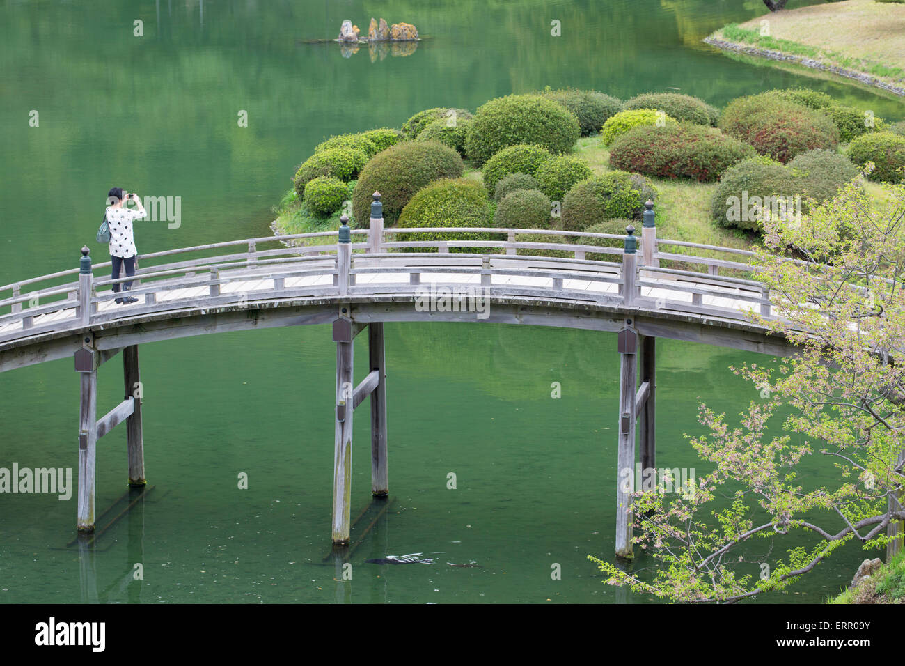 Woman on footbridge in Ritsurin-koen, Takamatsu, Shikoku, Japan Stock Photo