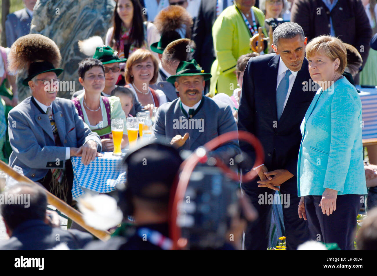 U.S. President Barack Obama talks to German Chancellor Angela Merkel, right, during a joint walk through the village of Kruen, southern Germany, Sunday, June 7, 2015 prior to the G-7 summit in Schloss Elmau hotel near Garmisch-Partenkirchen where the summit will start later the day. Photo: Matthias Schrader dpa Stock Photo