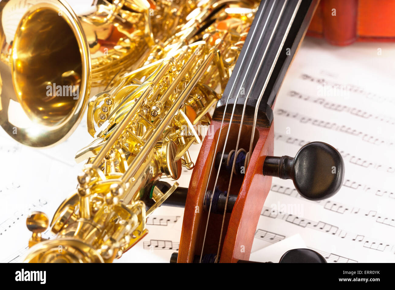 Violoncello tuning pegs and shiny alto saxophone Stock Photo Alamy