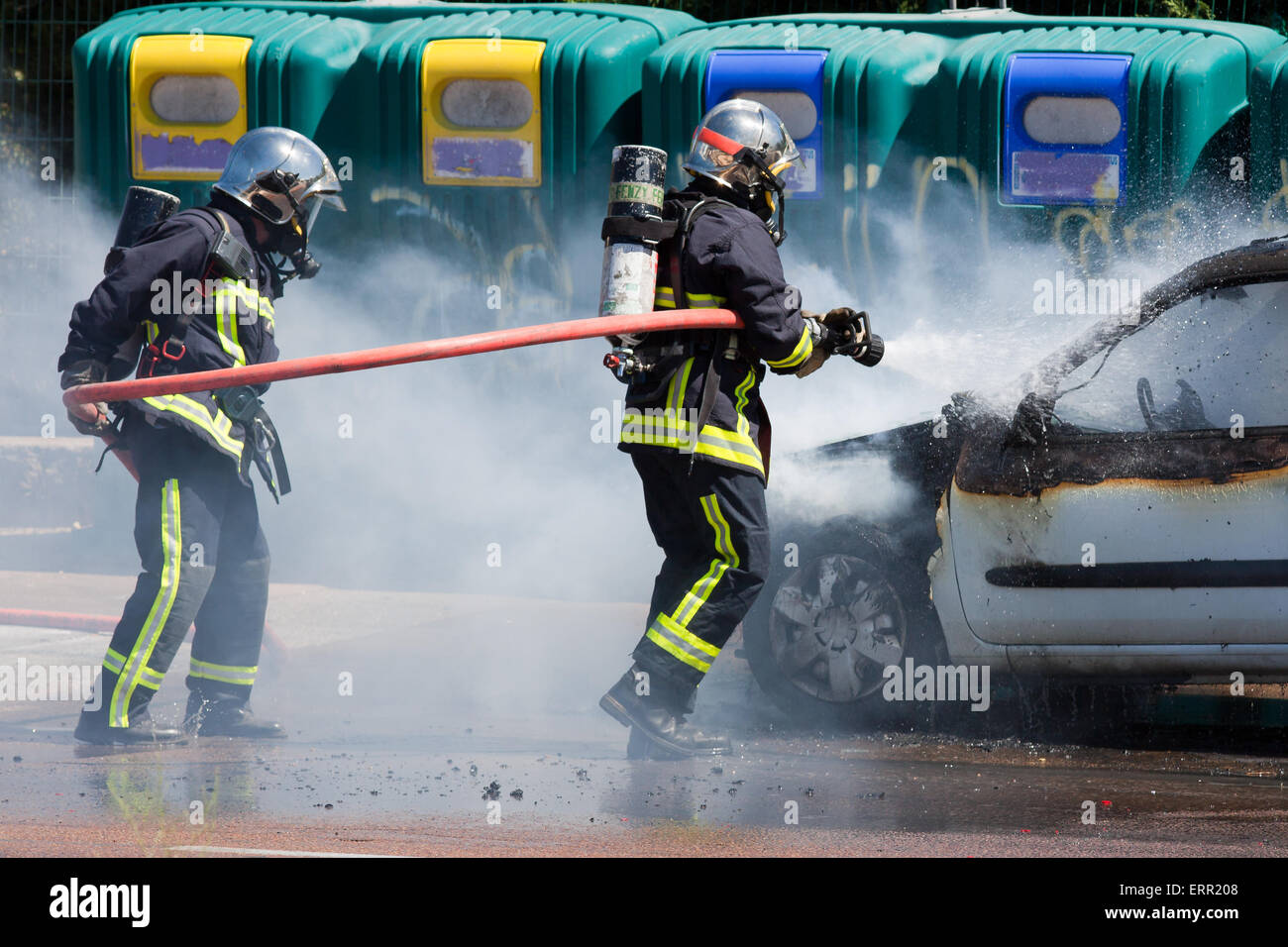 Two firefighters in action Stock Photo