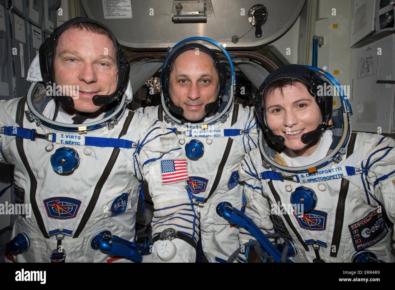 International Space Station Expedition 42 Flight Engineer Samantha Cristoforetti of the European Space Agency with fellow NASA astronaut Terry Virts (left) and Russian cosmonaut Anton Shkaplerov as they perform a checkout of their Russian Soyuz spacesuits in preparation for the journey back to Earth May 6, 2015 in Earth Orbit. Stock Photo