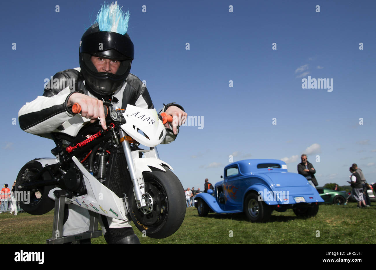 St. Michaelisdonn, Germany. 07th June, 2015. Motorcylist 'Dubios' prepares for the race with his mini motorcylce in St. Michaelisdonn, Germany, 07 June 2015. The drag race with motorcycles and cars takes place for the 9th time at the airfield in St. Michaelisdonn. Photo: AXEL HEIMKEN/dpa/Alamy Live News Stock Photo