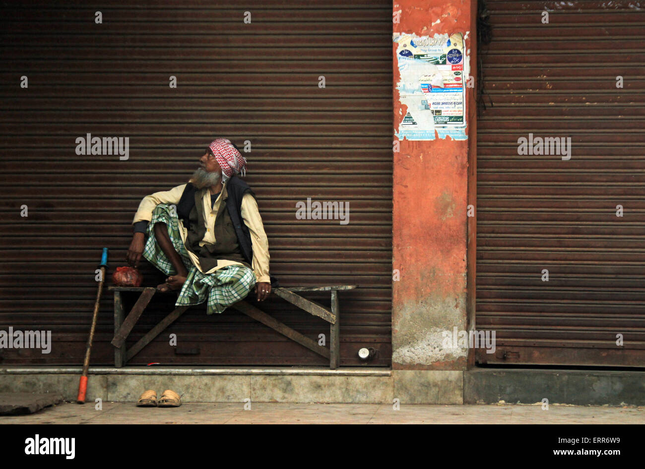 Old Indian Man Sitting on a Bench, Looking Sideways, Agra, India Stock Photo