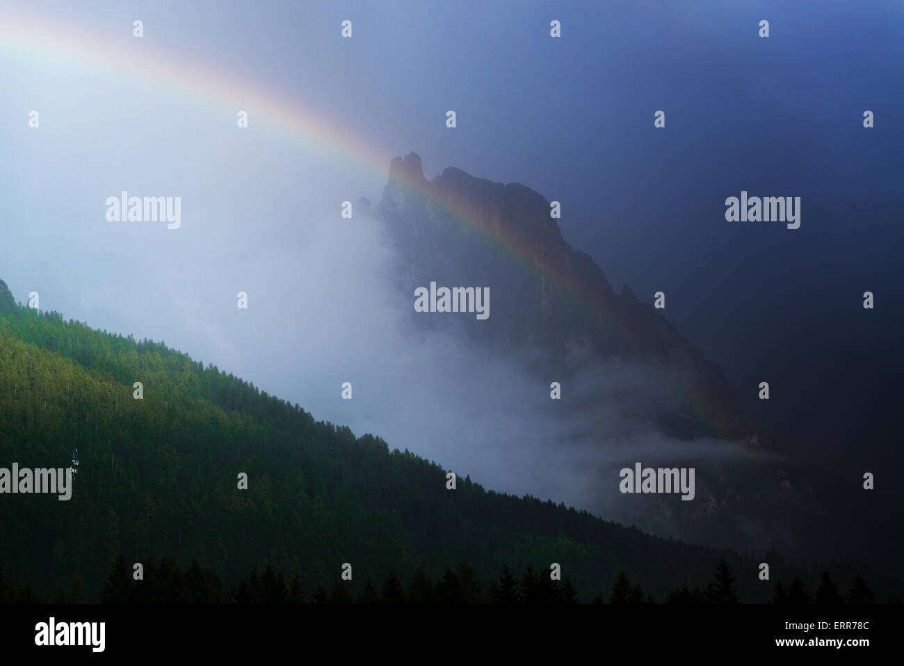 rainbow over the mountains during a thunderstorm in a summer sunset, San Martino di Castrozza - Trentino, Italy Stock Photo