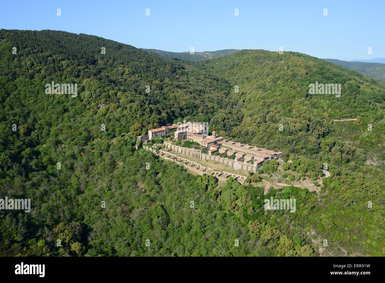 AERIAL VIEW. Monastery isolated in a mountainous area. La Verne Charterhouse, Collobrières, Var, French Riviera's backcountry, France. Stock Photo