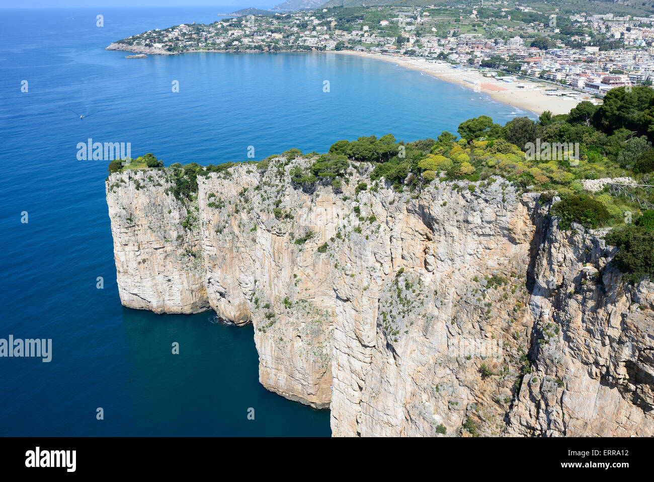AERIAL VIEW. Precipitous limestone cliff of Montagna Spaccata with the Serapo Beach in the distance. Gaeta, Province of Latina, Lazio, Italy. Stock Photo