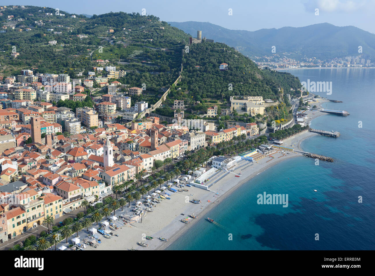 AERIAL VIEW. Seaside resort of Noli dominated by the medieval castle of Monte Ursino. Province of Savona, Liguria, Italy. Stock Photo