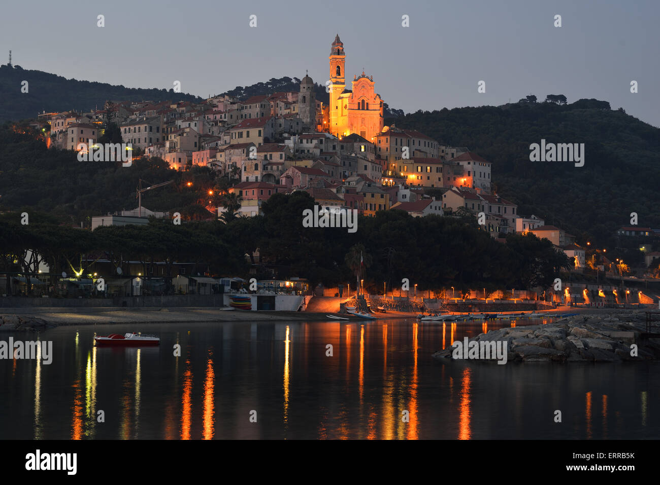 Seaside hilltop village at twilight with lights reflected on the sea. Cervo, Province of Imperia, Liguria, Italy. Stock Photo