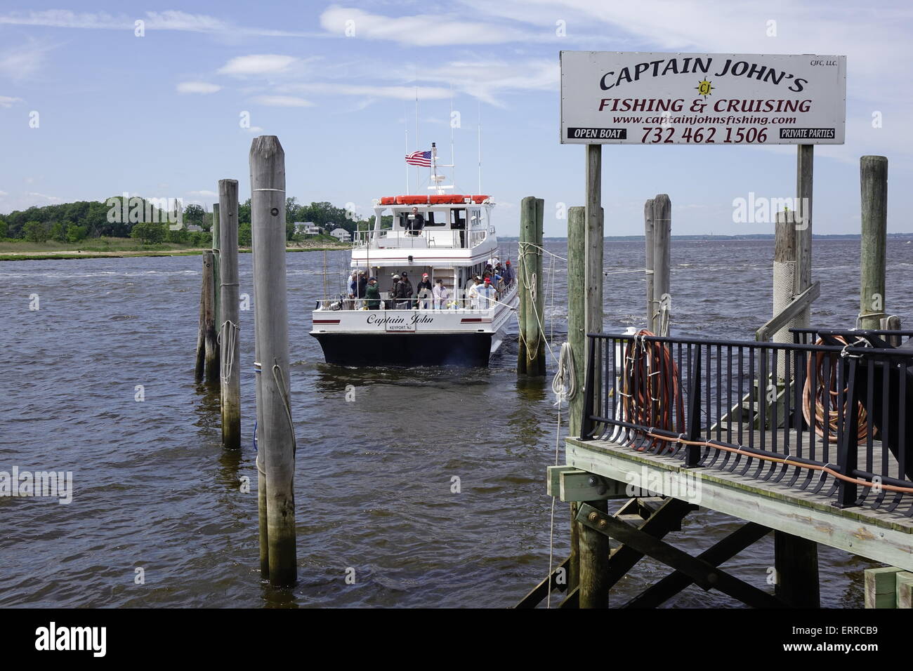 The Captain John, a fishing charter boat, returning to port in Keyport, New Jersey, with a group of happy fishermen Stock Photo