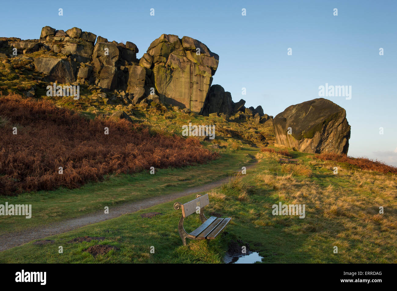 Scenic rural landscape of blue sky & early winter morning sunlight on a rocky outcrop - Cow and Calf Rocks, Ilkley Moor, West Yorkshire, England, UK. Stock Photo