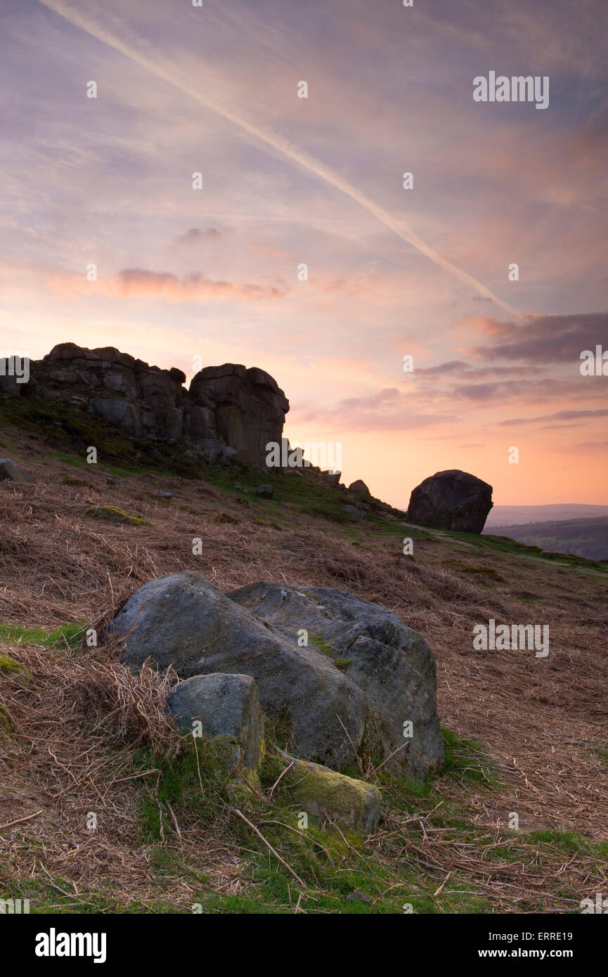 Beautiful rural scenic landscape of dramatic colourful sky at sunset over high rocky outcrop - Cow and Calf Rocks, Ilkley, West Yorkshire, England, UK Stock Photo