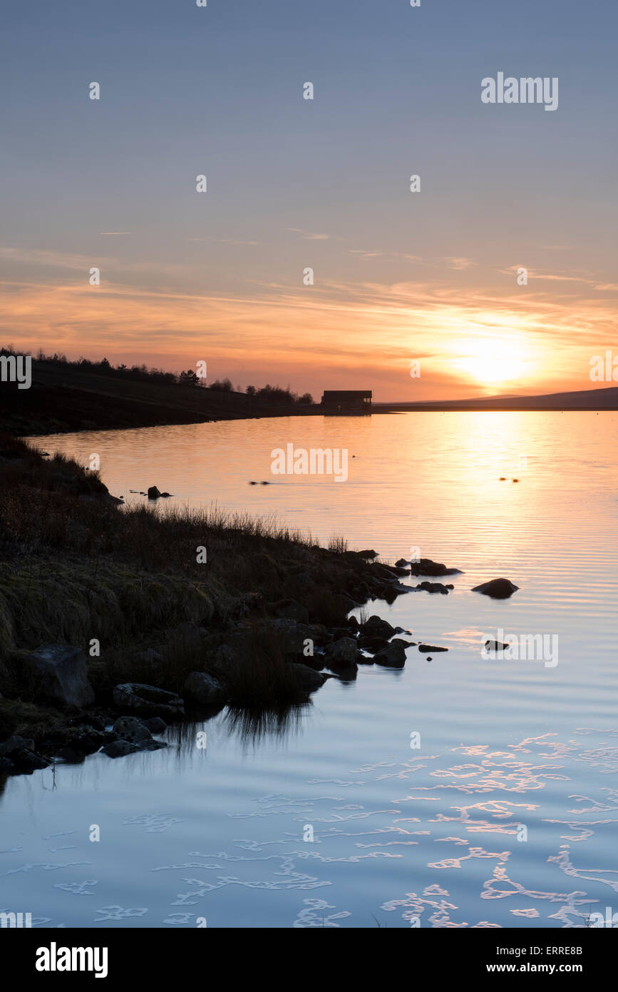 Beautiful scenic evening sunset over the calm water of rural, deserted Grimwith Reservoir, Yorkshire Dales landscape, North Yorkshire, England, UK. Stock Photo