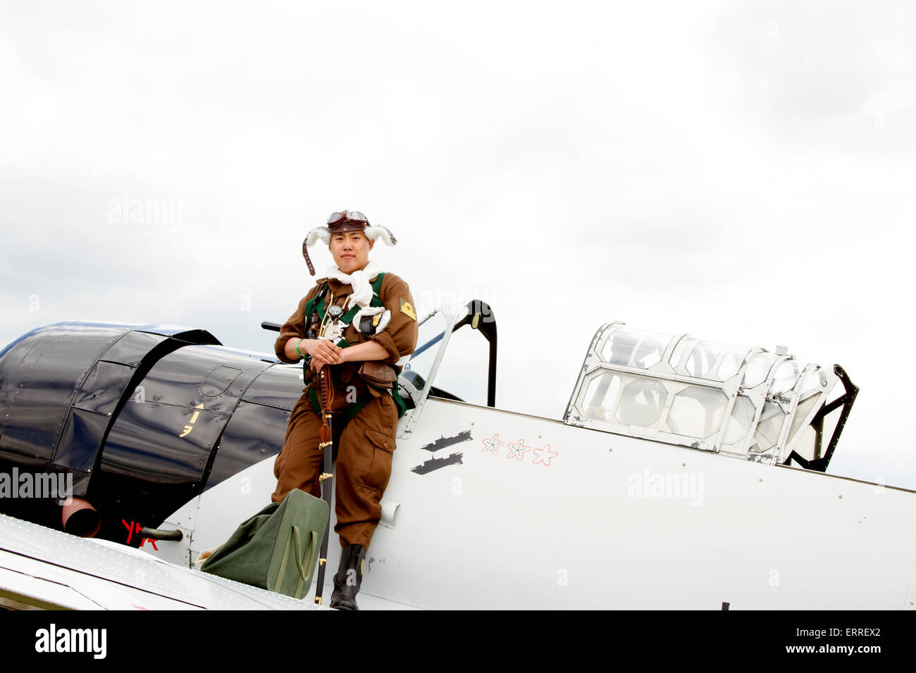 Reading, PA, USA - June 6, 2015 :  Japanese fighter pilot reenactor standing in uniform on plane wing. Stock Photo