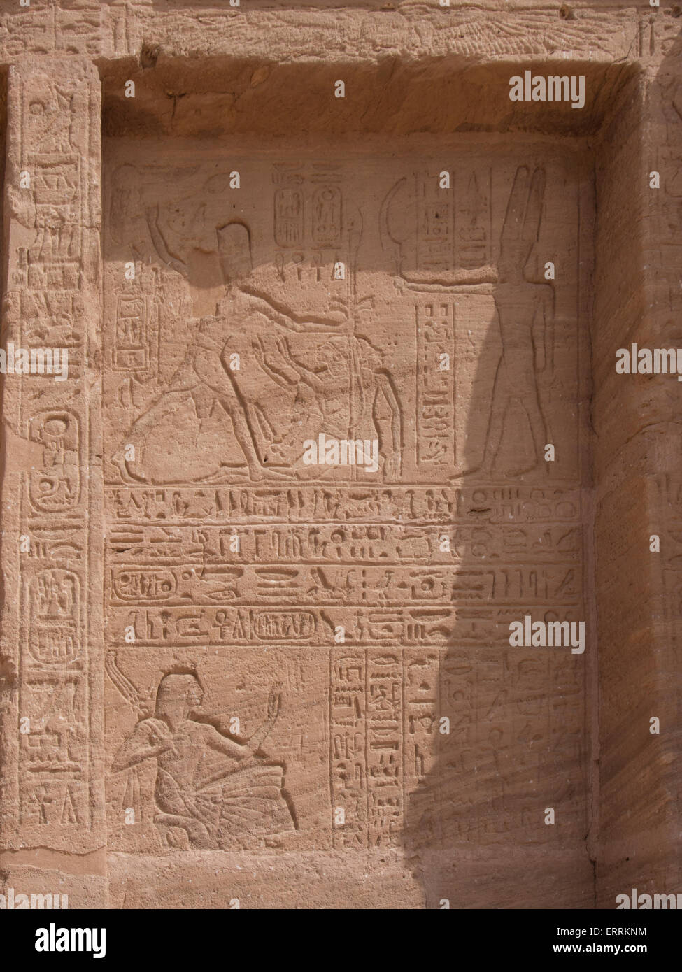 Relief at the Temple of Abu Simbel depicting  Ramses II holding his enemy by the hair whilst the god Amun offers him a weapon Stock Photo