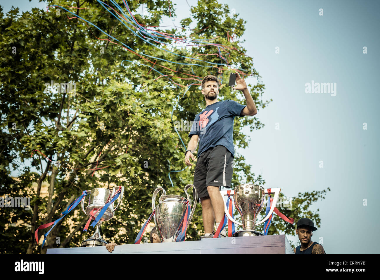 Barcelona, Catalonia, Spain. 7th June, 2015. FC Barcelona's centre-back GERARD PIQUE stands on top of the top deck of an open-topped bus during the triple victory parade through Barcelona to celebrate the 2nd 'triple' in the clubs history Credit:  Matthias Oesterle/ZUMA Wire/ZUMAPRESS.com/Alamy Live News Stock Photo