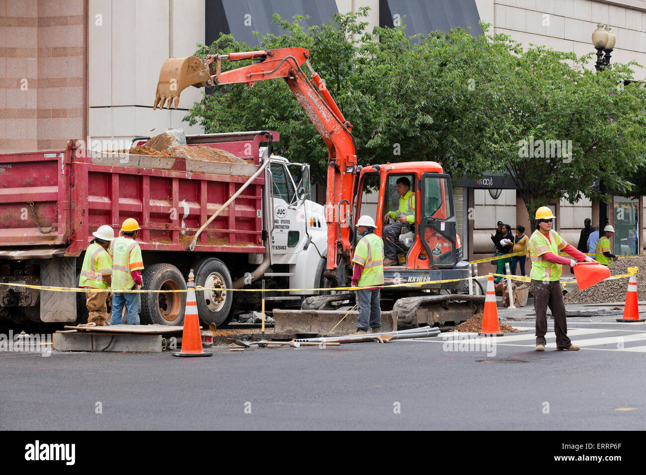 Municipal construction workers using backhoe - USA Stock Photo