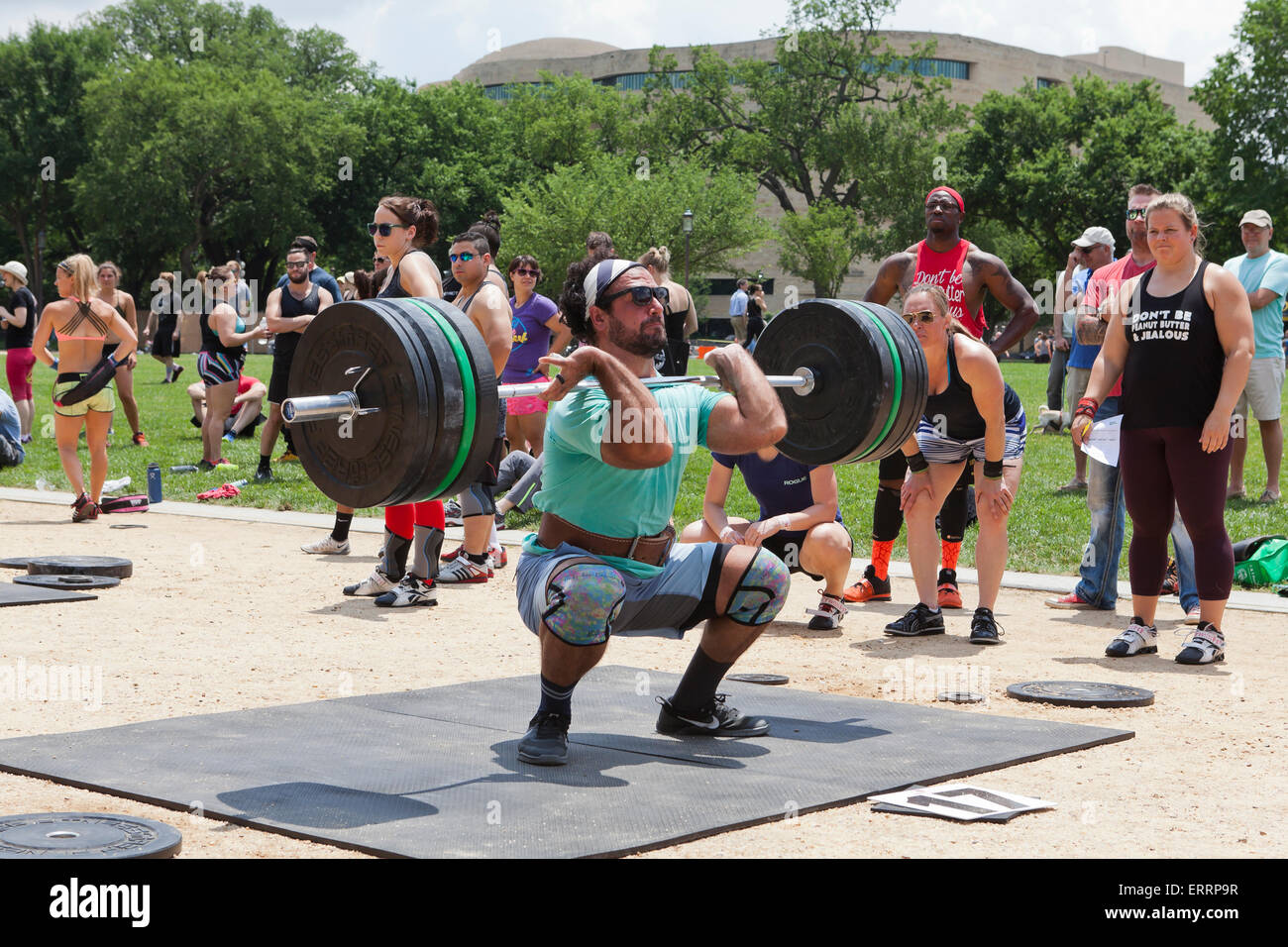 Man performing weightlifting at an outdoor fitness program USA Stock