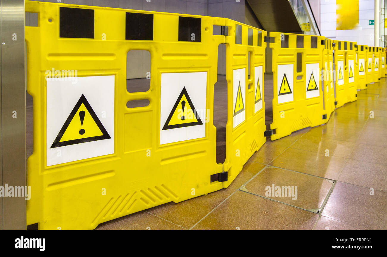 yellow mobile barriers with exclamation marks, please be careful and pay attention: there is a danger on your way Stock Photo