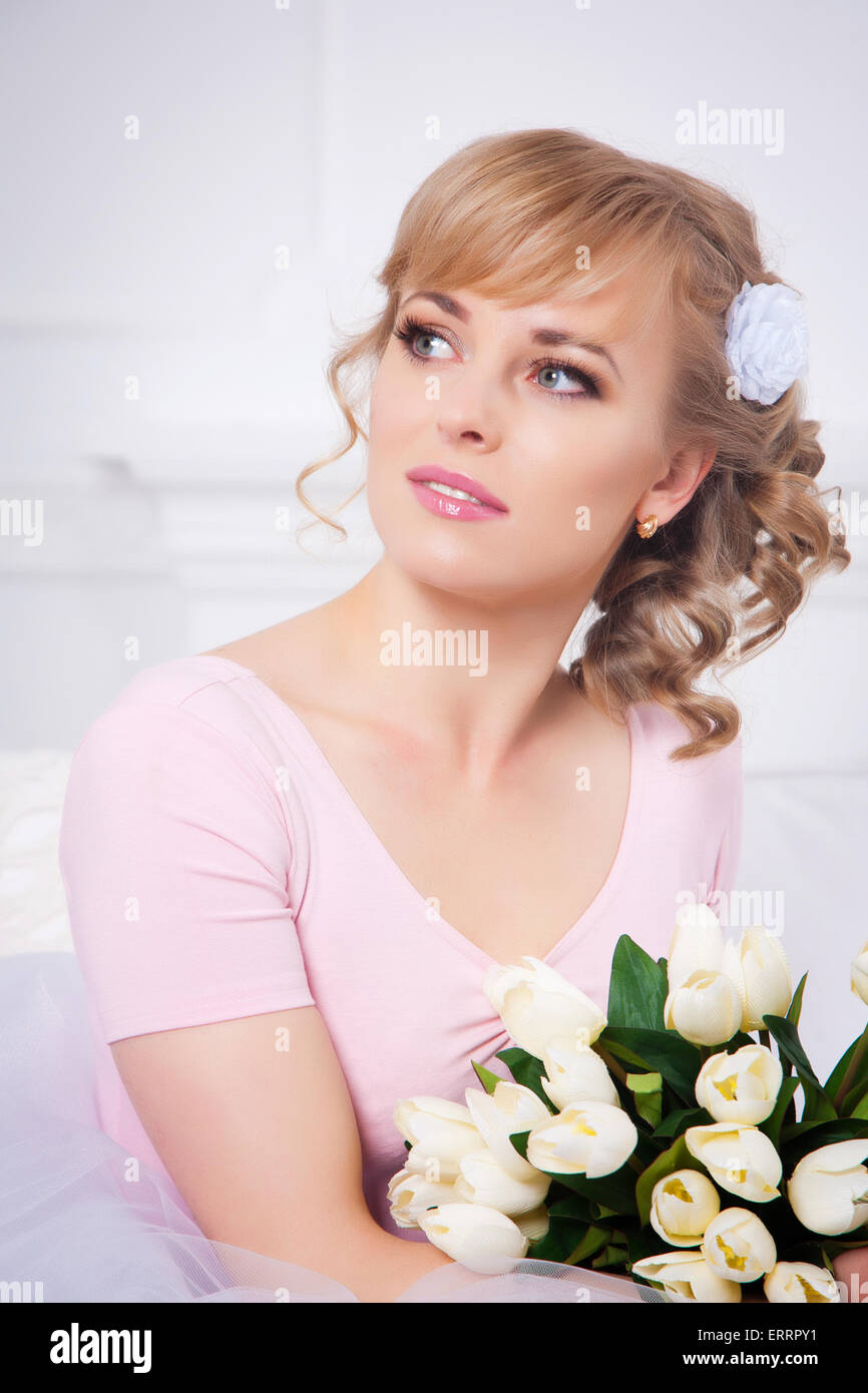 Portrait of a beautiful blonde woman with a bouquet of tulips Stock ...
