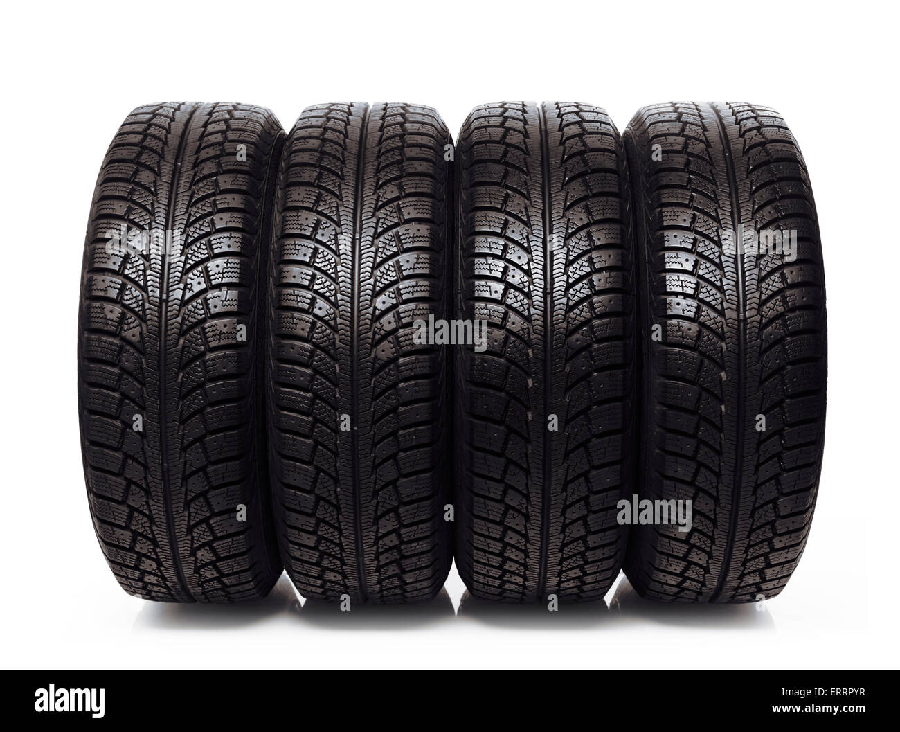 Set of four winter tires, car snow tyres isolated on white background Stock Photo