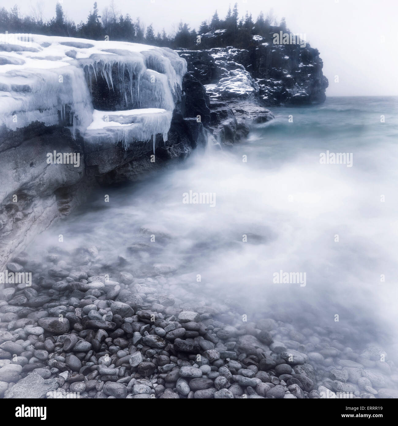 Frozen rocky shore of Georgian Bay in winter. Landscape nature scenery. Bruce peninsula, Ontario, Canada. Stock Photo