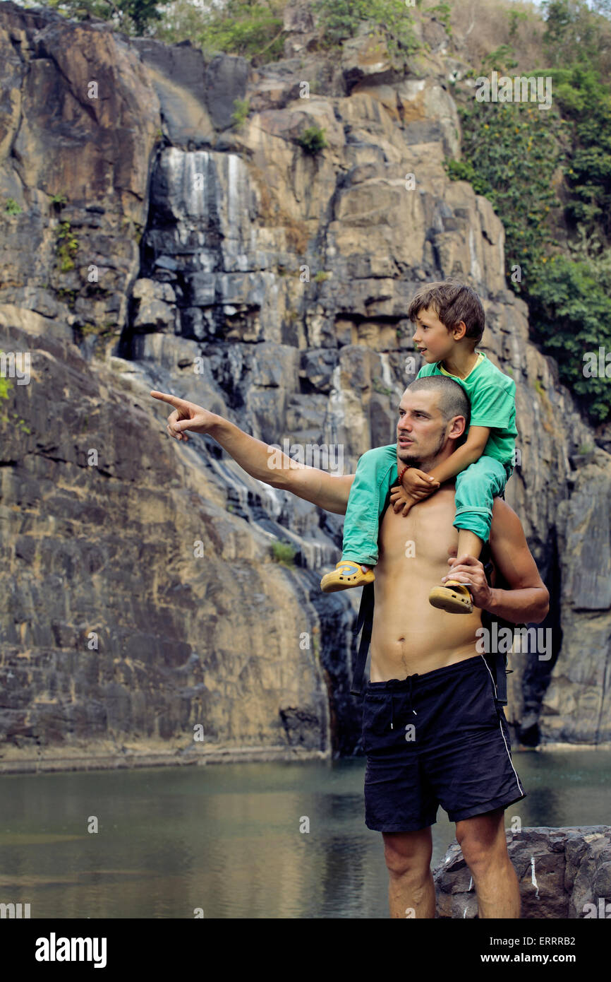 father and son making a trip to waterfall together, happy family Stock ...