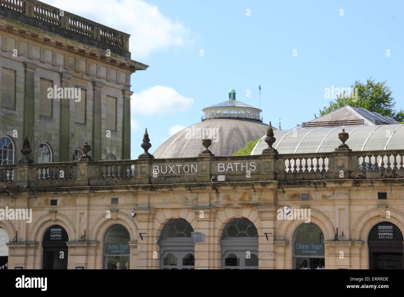 People pass by the Thermal Baths and Cavendish Arcade on The Crescent in Buxton, Derbyshire on a warm, sunny day, England UK Stock Photo