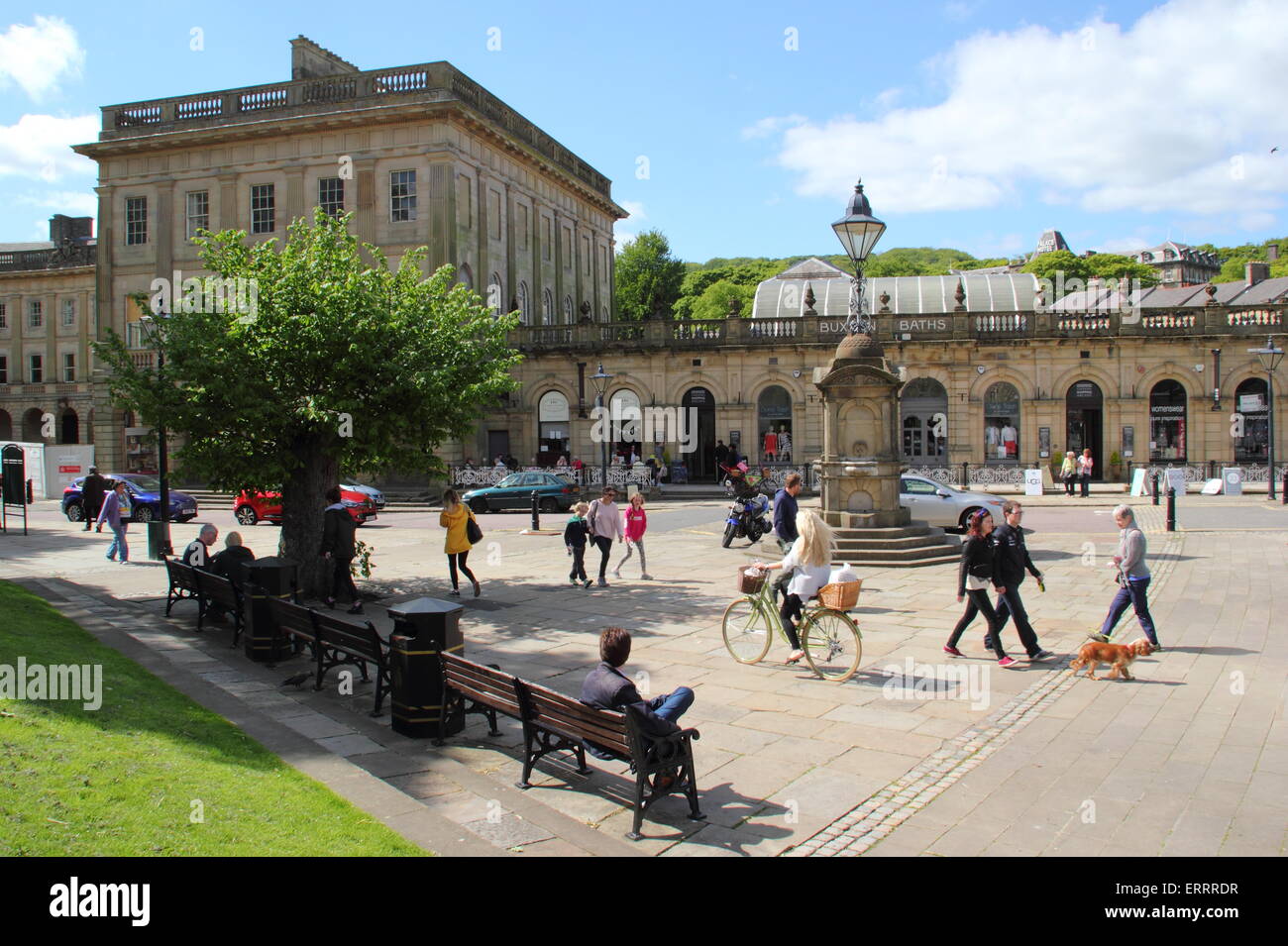 People pass by the Thermal Baths and Cavendish Arcade on The Crescent in Buxton, Derbyshire on a warm, sunny day, England UK Stock Photo