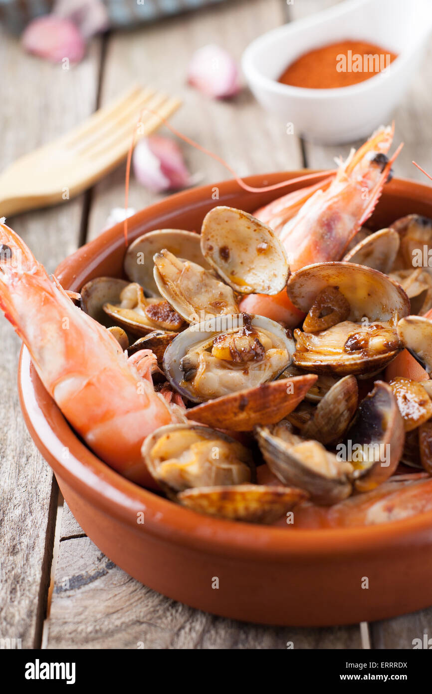 clams and prawns at paprika spanish seafood style Stock Photo Alamy