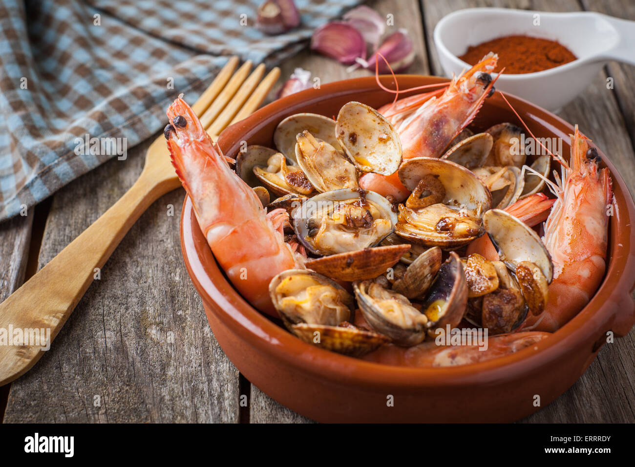 clams and prawns at paprika spanish seafood style Stock Photo Alamy