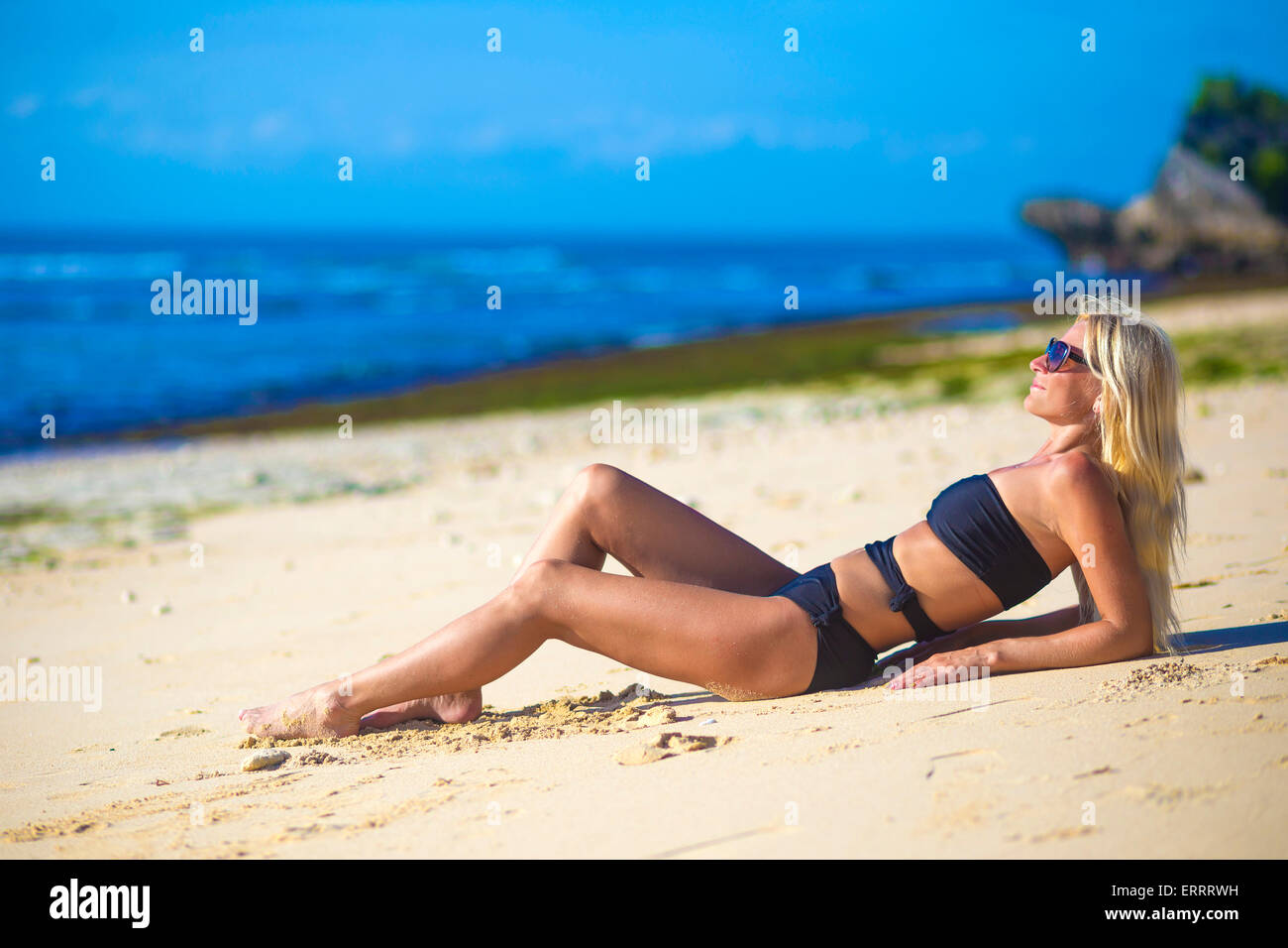 Young woman in bikini on a beach. Stock Photo