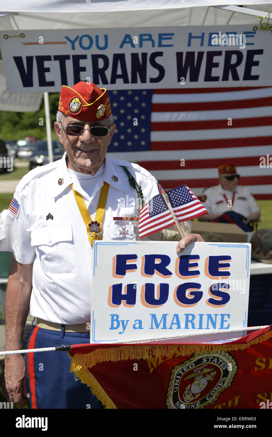 June 7, 2015 - Old Westbury, New York, United States - JOHN GIORDANO, of Whitestone, holds a FREE HUGS By a MARINE sign at the fundraising booth of the Marine Corps League North Shore Queens Detachment #240 at the 50th Annual Spring Meet Car Show sponsored by Greater New York Region Antique Automobile Club of America. Over 1,000 antique, classic, and custom cars participated at the popular Long Island vintage car show held at historic Old Westbury Gardens. (Credit Image: © Ann Parry/ZUMA Wire) Stock Photo